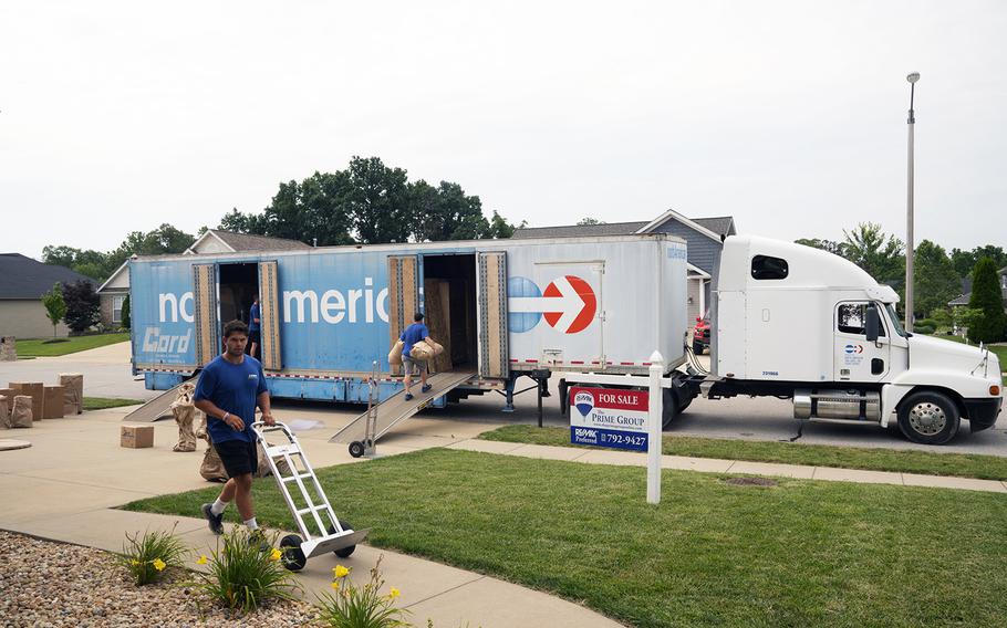 Movers pack a military family's property into boxes and load it into crates to be tranferred to a temporary storage facility in O'Fallon, Ill., July 1, 2019.