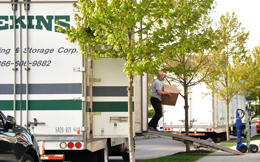 Movers unload household goods during delivery as the Navy continues to support servicemembers throughout the COVID-19 crisis.