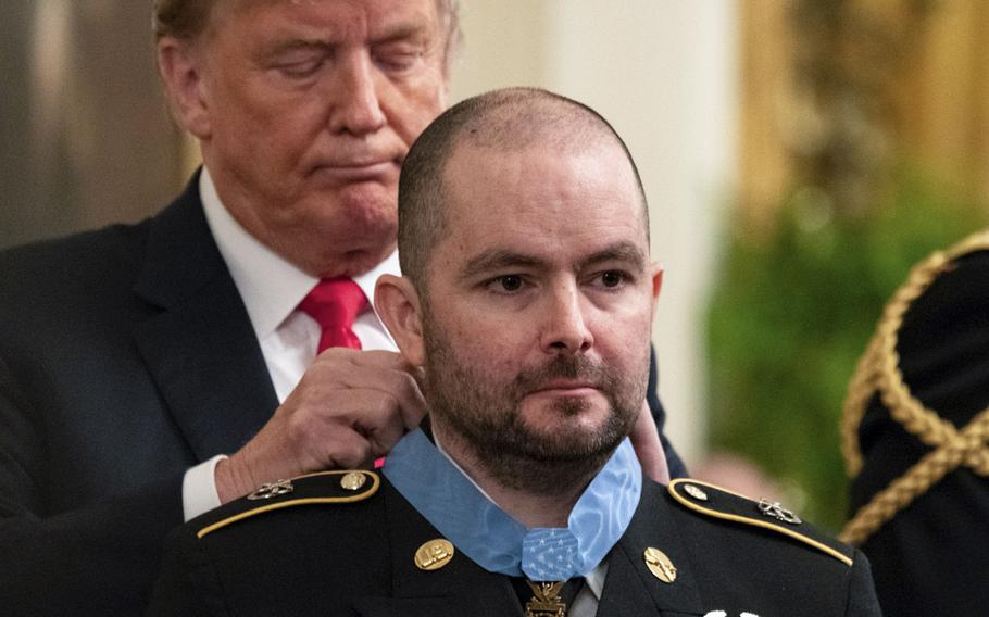 President Donald Trump presents former Army Staff Sgt. Ronald J. Shurer II the Medal of Honor during a White House ceremony on Monday, Oct. 1, 2018.