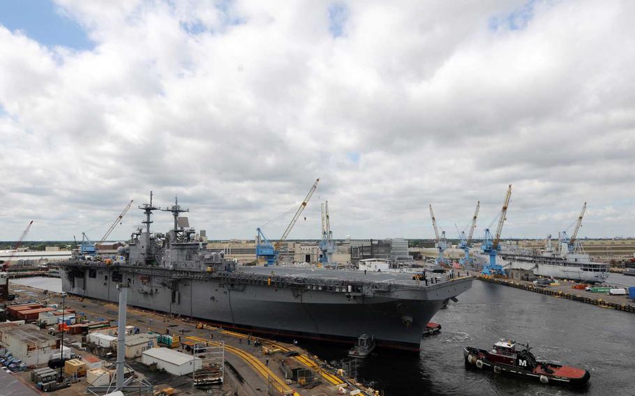 The amphibious assault ship USS Kearsarge is towed from a dry dock at the Norfolk Shipyard to a berth.  Kearsarge is undergoing a 10 month scheduled maintenance in dry dock and is expected to begin this fall.