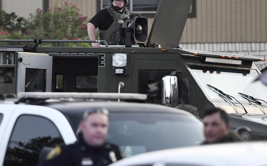 Corpus Christi police SWAT and FBI agents surround a home near Saratoga Boulevard, Thursday, May 21, 2020, in Corpus Christi, Texas. Lt. Michael Pena, spokesperson for the police department, could not confirm if it was related to the shooting at Naval Air Station-Corpus Christi on Thursday morning.