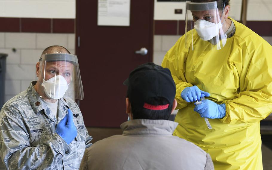 Soldiers and airmen from the Minnesota National Guard conduct COVID-19 testing at an armory on May 23, 2020.