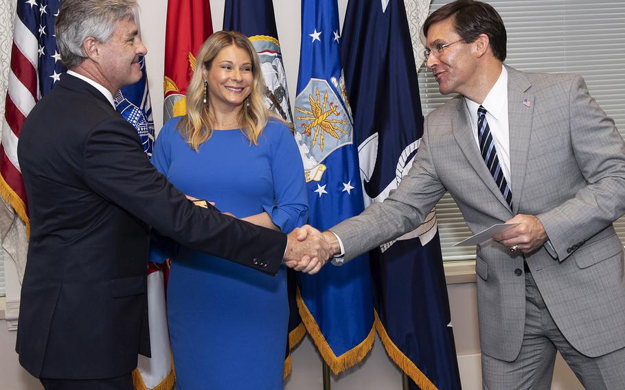 Kenneth Braithwaite is congratulated by Defense Secretary Mark Esper after being sworn in as Secretary of the Navy in a ceremony at the Pentagon, May 29, 2020. With them is Braithwaite's wife. Melissa.