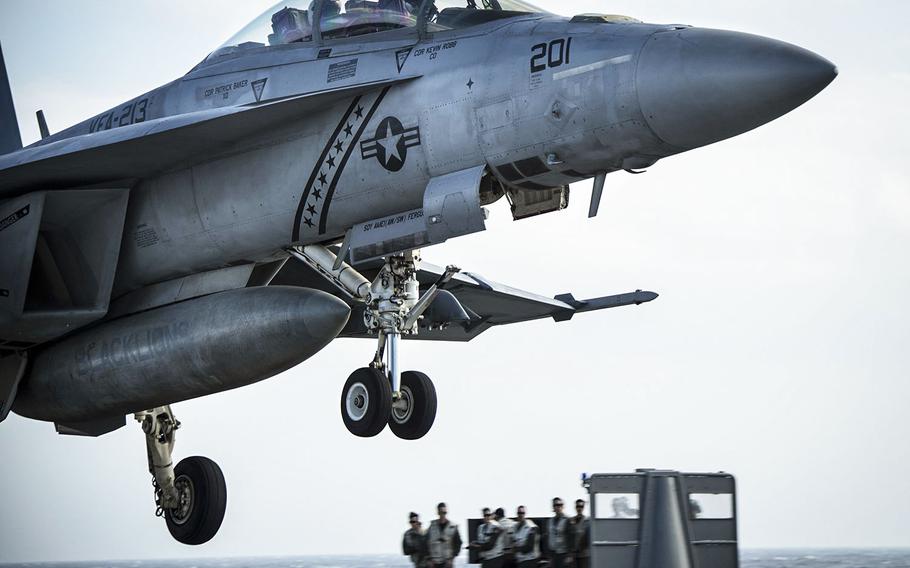 In a January 13, 2018 photo, an F/A-18F Super Hornet assigned to the "Black Lions" of Strike Fighter Squadron (VFA) 213 prepares to land on the flight deck of USS Gerald R. Ford.