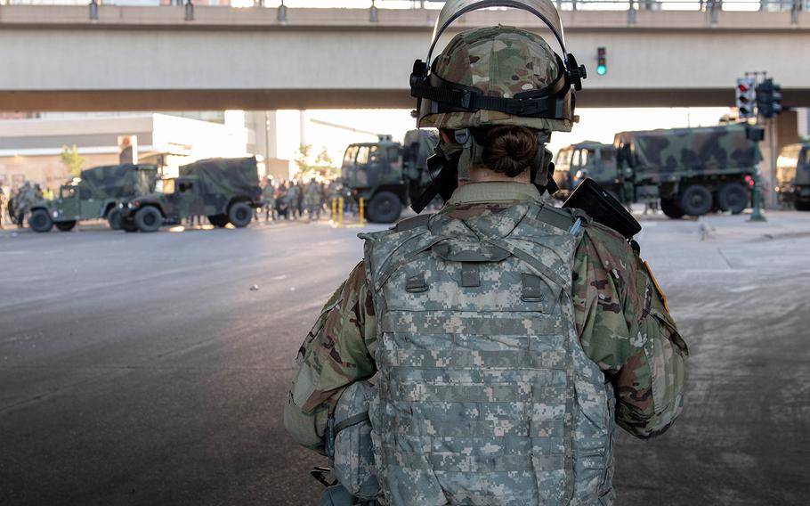 Troops from the Minnesota National Guard conduct a security mission alongside local law enforcement under State Highway 55 in Minneapolis on Friday night.