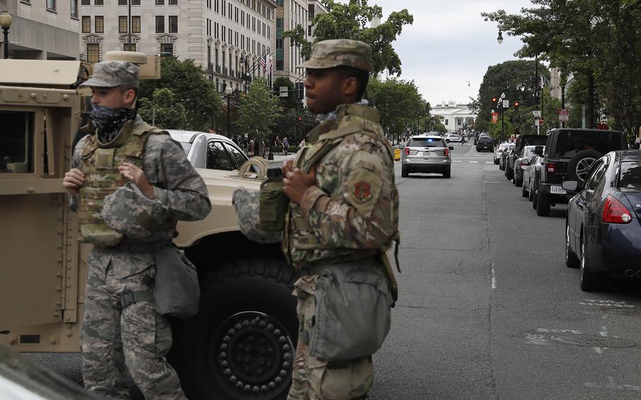 Members of the DC National Guard block an intersection on 16th Street as demonstrators gather to protest the death of George Floyd, Tuesday, June 2, 2020, near the White House in Washington. 