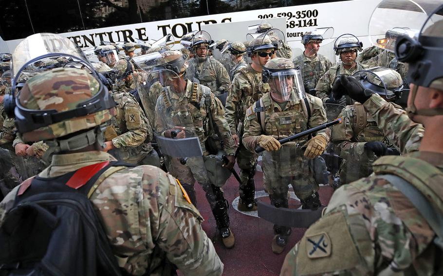 Soldiers with the South Carolina National Guard arrive on buses as demonstrators continue to protest the death of George Floyd, Wednesday, June 3, 2020, near the White House in Washington.