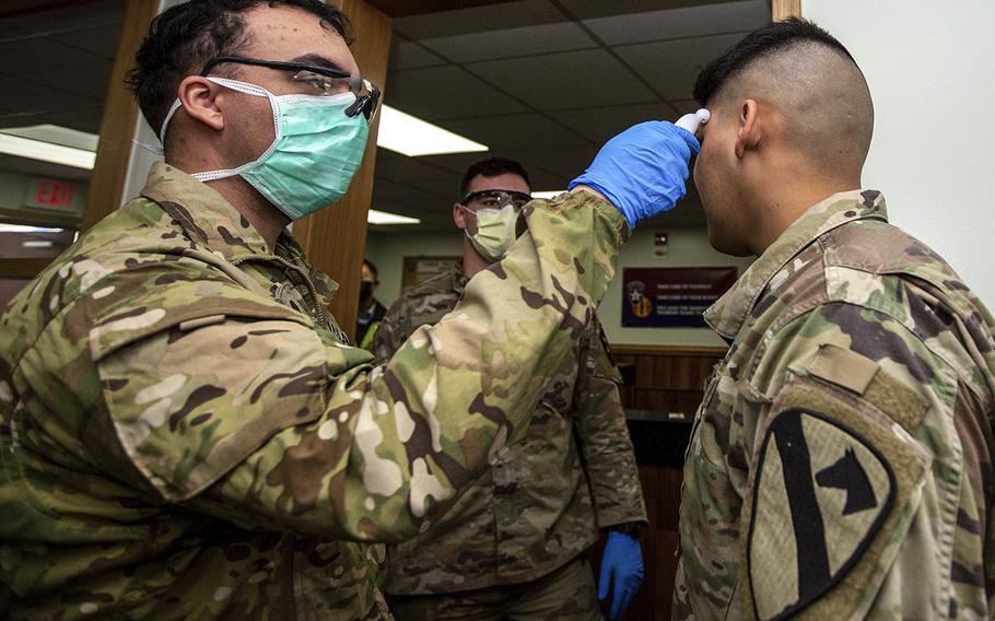 Soldiers stationed on U.S. Army Garrison Casey conduct pre-screening processes on individuals awaiting entry to the base in South Korea, Feb. 26, 2020.