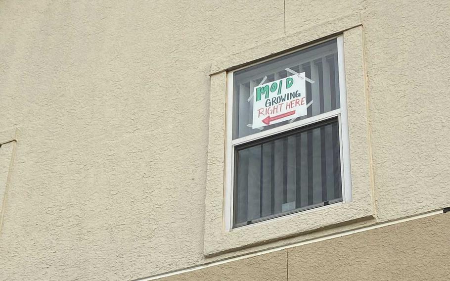 Courtney Hamilton hung a sign in her window to point to mold found last week in her house on base at Fort Hood, Texas. She was told in January that the house had been cleared of mold, and the Hamiltons are now one of nine families to file a lawsuit Monday against Lendlease, the private company that manages housing at the base. 