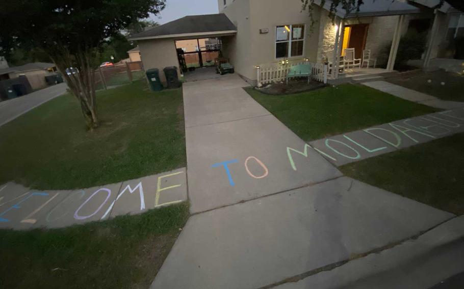 Courtney Hamilton used sidewalk chalk last week to vent her frustration with Lendlease, the private company that manages base housing at Fort Hood, Texas. “Welcome to Moldague,” written on the sidewalk outside her home is based on the name of the neighborhood, Montague Village. The Hamiltons are one of nine families to file a lawsuit Monday against private housing company Lendlease because they say their homes had toxic levels of mold due to poor maintenance. 