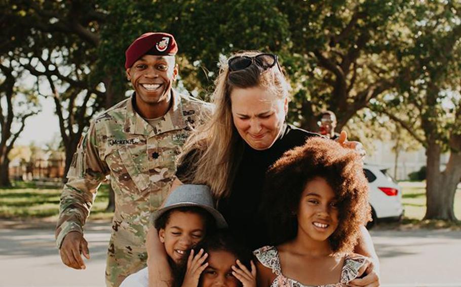 Lt. Col. Simon McKenzie gets ready to surprise his family during a photo shoot. 