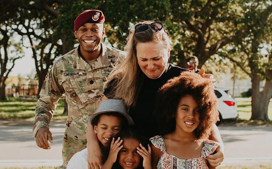 Lt. Col. Simon McKenzie prepares to reunite with his family after a deployment to Quatar.