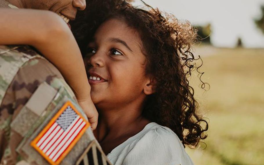 Five-year-old Lawton gives her dad Lt. Col. Simon McKenzie a hug as he returns from his 2020 deployment to Quatar.