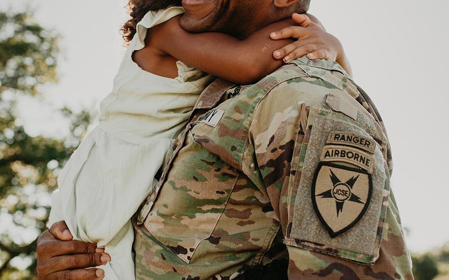 Lt. Col. Simon McKenzie is all smiles as he reunites with his family after his deployment.