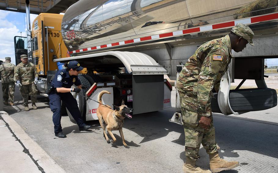 Spc. Afeez Amusan, right, a truck driver with the Texas Army Guard’s Company A, 536th Brigade Support Battalion, inspects a tractor-trailer truck alongside a U.S. Customs and Border Protection agent at the Pharr, Texas, port of entry facility on Aug. 21, 2018.