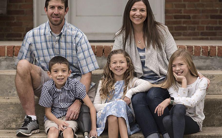 Retired Army Capt. Ryan Kules with his wife Nancy and their children Jillian, Liv and Evan. Injured by a roadside bomb in 2005, Kules lost his right arm above the elbow and his left leg above the knee. He now works with Wounded Warrior Project and helped push for new legislation to get more government funding for disabled veterans to modify their homes.
PHOTO COURTESY RYAN KULES.
