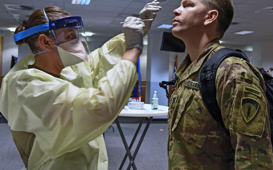 A medical professional from the Wiesbaden Army Health Clinic administers a COVID-19 test to a soldier on June 30, 2020, at the Mission Command Center at U.S. Army Garrison Wiesbaden, Germany.