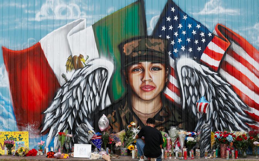 Juan Cruz, boyfriend of Army soldier Vanessa Guillen, kneels in front of a mural honoring her Sunday, July 5, 2020, in Houston. 