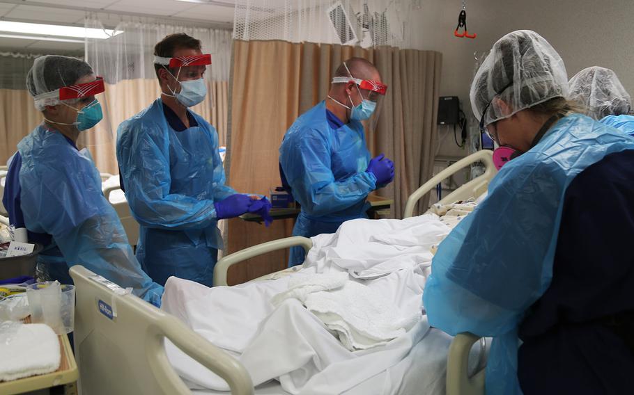 In a July 10, 2020 photo, U.S Army critical care nurses 1st Lt. Charles Gilcrist, 1st Lt. Lauryn Hudgins and 1st Lt. Colton Whitehouse from Urban Augmentation Medical Task Force - 627 work to provide medical care to a COVID-19 patient alongside Baptist Hospital medical staff, in San Antonio, Texas.