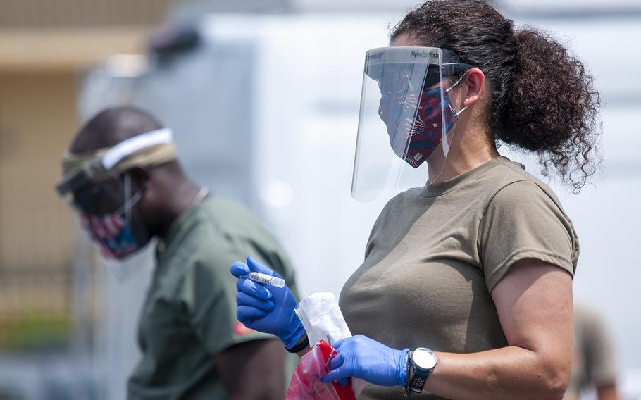 U.S. Air Force Tech. Sgt. Leslie Hamill, a medical technician with the Delaware Air National Guard's 166th Medical Group, wears personal protective equipment at a walk-up testing site for COVID-19 in Rehoboth Beach, Del., on July 7, 2020. 