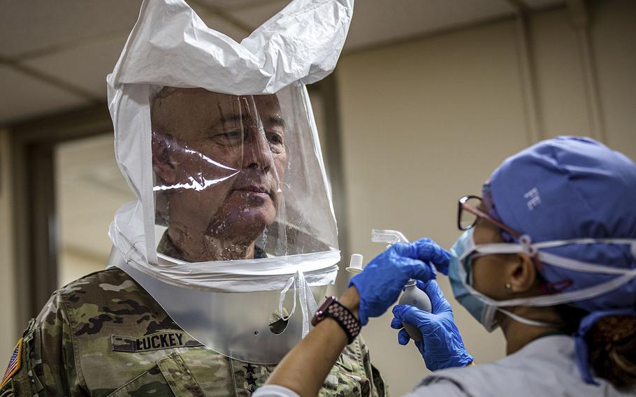 Lt. Gen. Charles D. Luckey, commanding general of the U.S. Army Reserve Command, gets fitted for a proper mask before a tour at University Hospital in Newark, N.J., April 21, 2020.