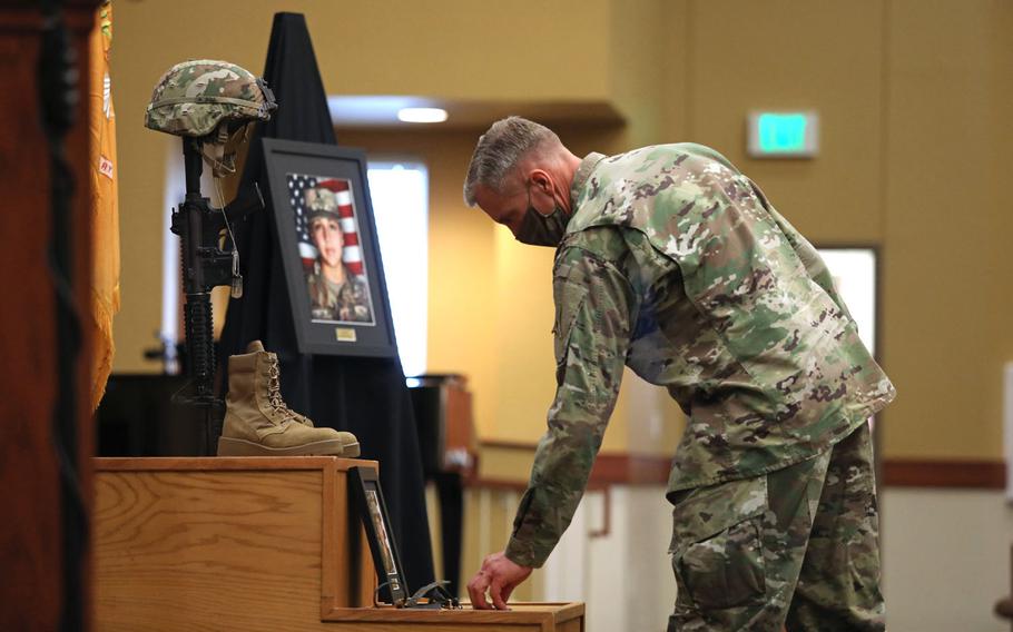 Maj. Gen. Scott Efflandt, III Corps and Fort Hood deputy commanding general, leaves a coin at the base of a Soldier's Cross for fallen Soldier Spc. Vanessa Guillen at the conclusion of a unit memorial service in the Spirit of Fort Hood Chapel, Fort Hood, Texas, July 17.