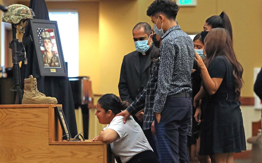 The family of Spc. Vanessa Guillen grieves in front of her Soldier's Cross during her unit memorial ceremony at Fort Hood, Texas, July 17. 