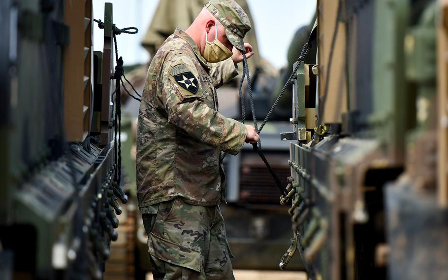 A soldier assigned to Bravo Company, 2nd Battalion, 12th Cavalry Regiment, conducts vehicle preparation procedures during Phase II of DEFENDER-Europe 20, Drawsko Pomorskie Training Area, Poland, July 20, 2020. In response to COVID-19, DEFENDER-Europe 20 was modified in size and scope.