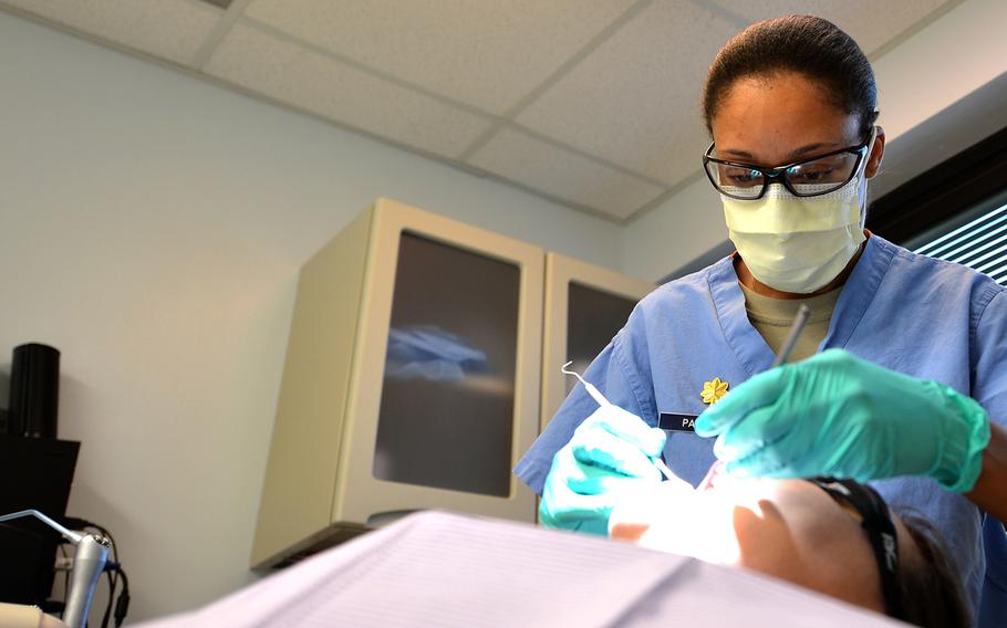 U.S. Air Force Major Rachael Parrish, 20th Dental Squadron general dentist, performs an oral exam on Airman 1st Class Amie Bickford, 20th Equipment Maintenance Squadron munitions technician at Shaw Air Force Base, S.C., March 13, 2017. 