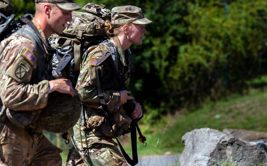 Army Sgt. Jake Weingarts, left, and Lt. Laura Benz walk to the next location during the 21st Theater Sustainment Command Best Medic Competition in Baumholder, Germany, Aug. 21, 2019. The competition tests medical and warfighter skills.