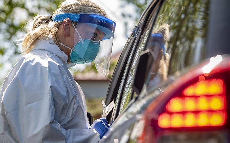 A West Virginia National Guard airman provides a coronavirus test to a citizen on May 22, 2020, in Charleston, W. Va.