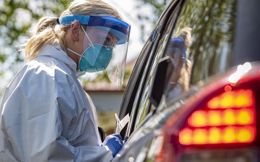 A West Virginia National Guard airman provides a coronavirus test to a citizen on May 22, 2020, in Charleston, W. Va. 