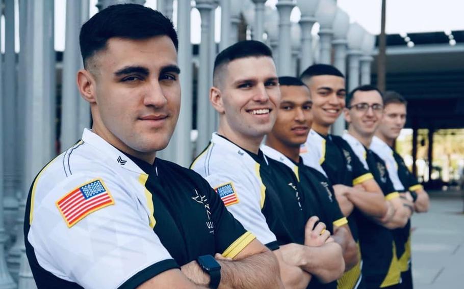 Staff Sgt. Nicholas Mackay (left) poses in a promotional photo for the newly formed Army Esports team. Mackay was one of 6,500 applicants for the competitive video gaming team, becoming one of just 16 ultimately selected.