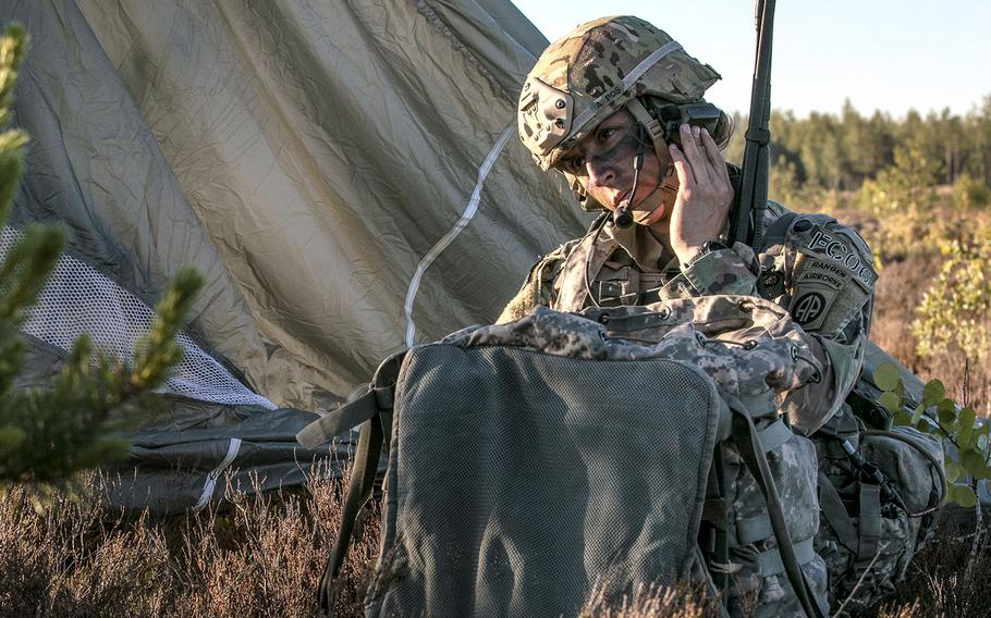 In a June 9, 2018 photo, Capt. Shaye Haver, commander of Company C., 1st Battalion, 508th Parachute Infantry Regiment, 3rd Brigade Combat Team, 82nd Airborne Division, Fort Bragg, N.C., performs radio checks on Adazi Base, Latvia, after parachuting from a C-17 Globemaster III during Swift Response 18.