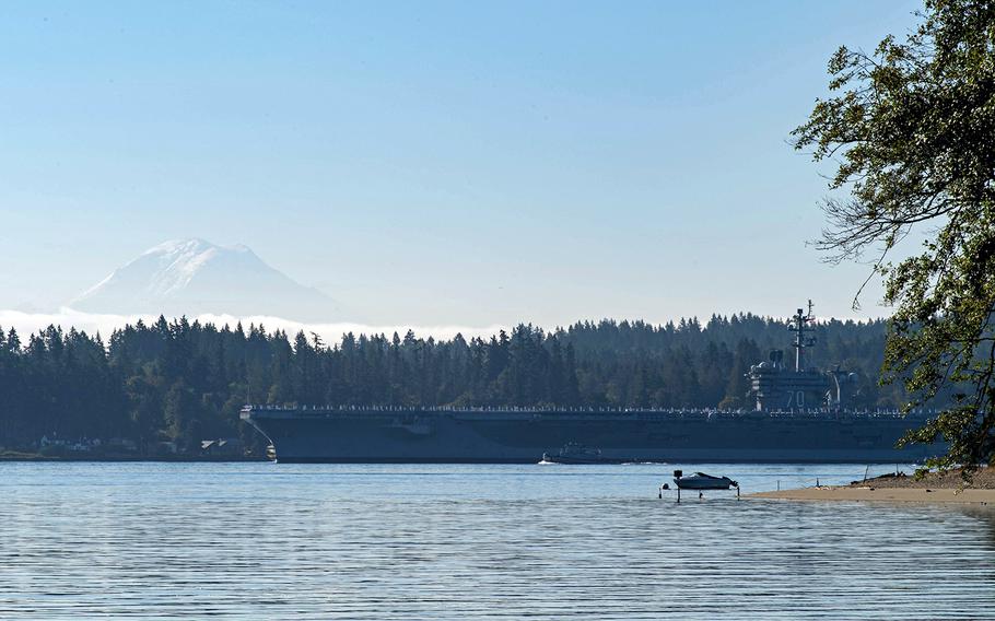 The aircraft carrier USS Carl Vinson passes Waterman Point, Wash., on its way out to sea, Aug. 23, 2020. 