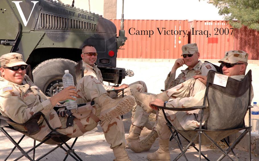 From left to right:  Spc. Levi Ward, Spc. Brian Gordiel, 1st Sgt. William Degenhardt, and Sgt. 1st Class John Sury, take a break under a palm tree Aug. 27, 2005 at Camp Victory, Iraq.  The troops are members of the Illinois Army National Guard's 2nd Battery, 123rd Field Artillery Regiment, stationed at the International Zone, Iraq. 