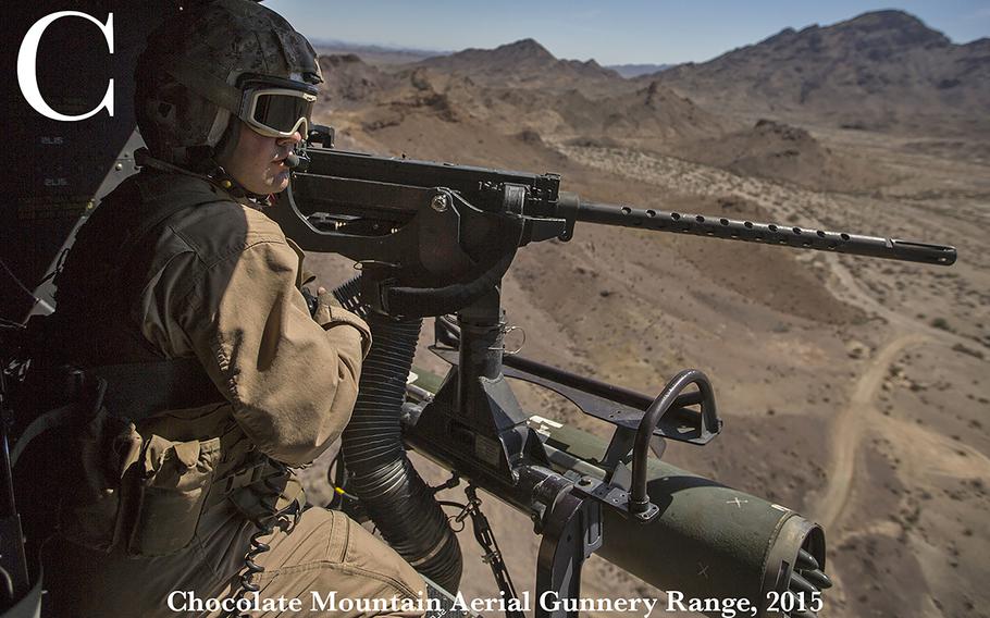 U.S. Marine Corps Sgt. Robert Brown, with Marine Light Attack Helicopter Squadron 469 (HMLA-469), looks out the UH-1Y Venom during an aerial gunnery refinement exercise at Mt. Barrow, Chocolate Mountain Aerial Gunnery Range, Calif., Sept. 30, 2015. This exercise was part of the Weapons and Tactics Instructor (WTI) Course 1-16, a seven week training event, hosted by Marine Aviation Weapons and Tactics Squadron One (MAWTS-1) cadre, which emphasizes operational integration of the six functions of Marine Corps aviation in support of a Marine Corps Air Ground Task Force. MAWTS-1 provides standardized advanced tactical training and certification of unit instructor qualifications to support Marine Aviation Training and Readiness and assists in developing and employing aviation and tactics. 