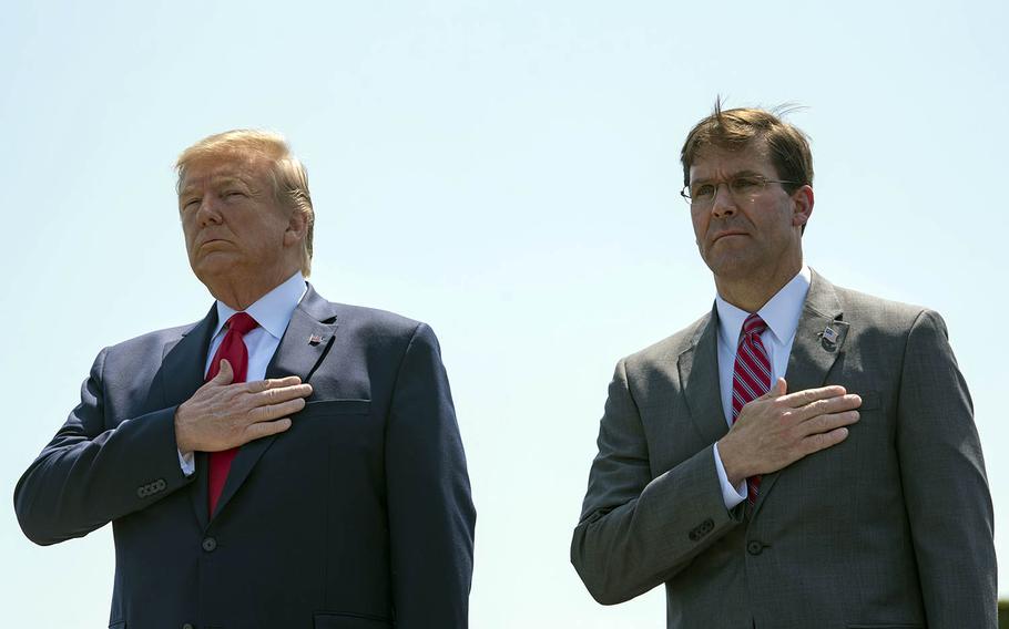 President Donald Trump and Secretary of Defense Mark Esper stand as the national anthem is played outside the Pentagon, July 25, 2019. 