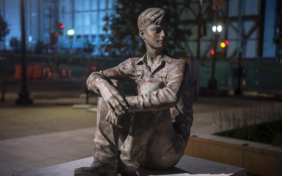 A life-size sculpture of Ike Eisenhower as a young man sitting on a pedestal decorates the west end of the new Dwight D. Eisenhower Memorial in Washington D.C., on Sept. 8, 2020.