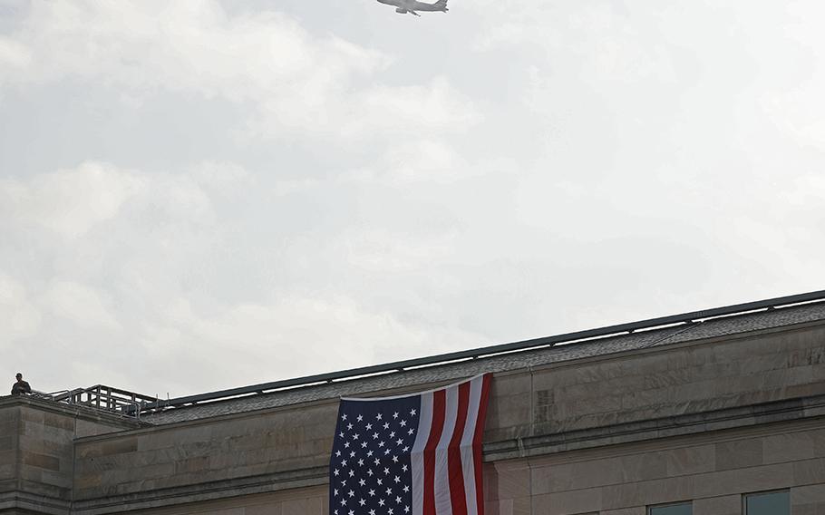A airplane flies above the site at the Pentagon where 19 years ago hijackers crashed American Airlines Flight 77 into the building, killing 184 men, women and children. The Pentagon held a 9/11 observance ceremony Friday Sept. 11, 2020, to remember the sacrifice of those lost in 2001. 