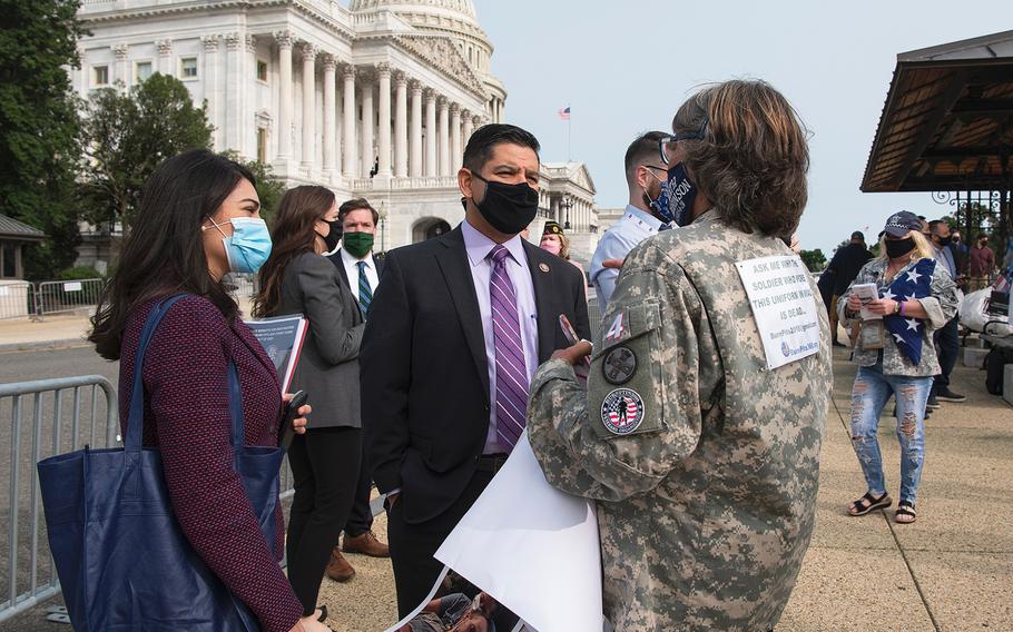 U.S. Rep. Raul Ruiz, D-Calif., speaks with Susan Freier in front of the U.S. Capitol in Washington on Tuesday, Sept. 15, 2020. Freier, whose  late son-in-law Sgt. 1st Class Heath Robinson died of cancer in May, joined other advocates to lobby for legislation that would provide benefits to military veterans who have been exposed to toxins from burn pits used at overseas locations.