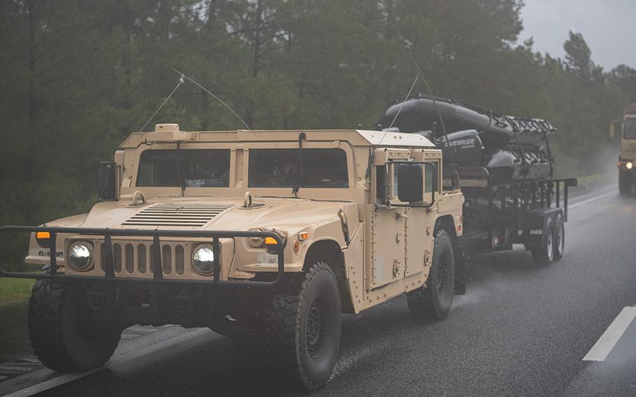 Military vehicles, some towing boats for high water search and rescue, move toward affected areas of Floriday as Hurricane Sally came ashore on Sept. 16, 2020.