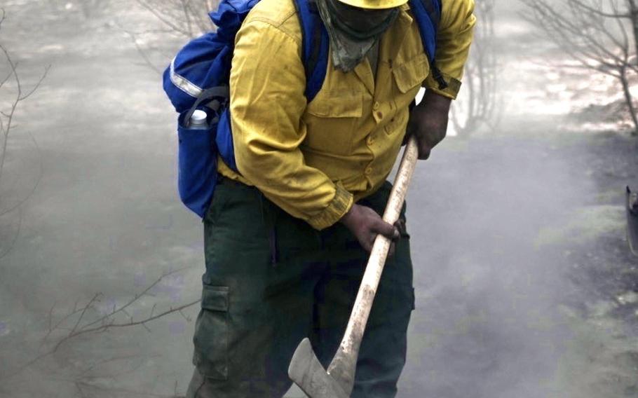 Spc. Zachary Anderson of the Oregon Army National Guard digs out a pit of smoldering embers Sept. 14, 2020, during mop-up operations at the Two Four Two Fire near Chiloquin, Ore. About 1,200 Oregon National Guard members are supporting overall firefighting efforts with aviation and ground crews, in addition to supporting county liaison teams and Oregon State Police with traffic control points and fatality search-and-rescue operations.