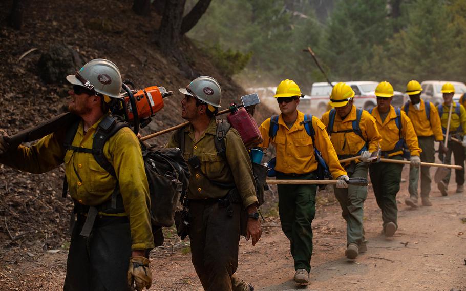 A Billings, Mont.-based crew from the Bureau of Land Management lead soldiers with the 14th Brigade Engineer Battalion on Sept. 6, 2020, as they prepare a road for burnout operations at the August Complex Fire in Mendocino National Forest. Burnout operations involve clearing out easily combustible wildfire fuel such as trees and foliage, helping prevent the fire’s spread.