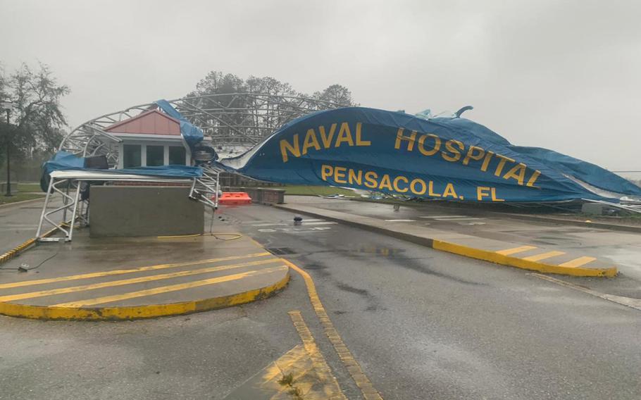 Naval Hospital Pensacola posted photographs showing wind damage to structures outside the facility, and water and other damage inside the hospital.