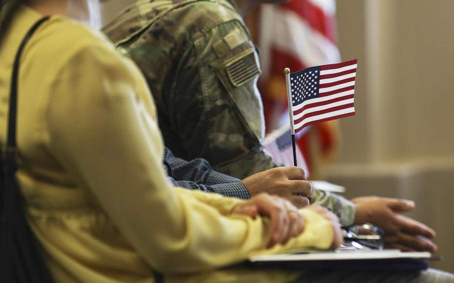 A U.S. flag is held during a naturalization ceremony at the Army Community Services on Fort Carson, Colo., Sep. 20, 2019.