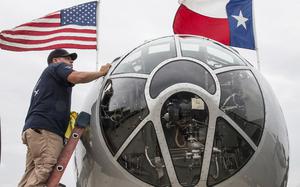 A crew member polishes the windows of the B-29 Superfortress "Fifi" during a Thursday media event for Friday's Arsenal of Democracy flyover of Washington, D.C.