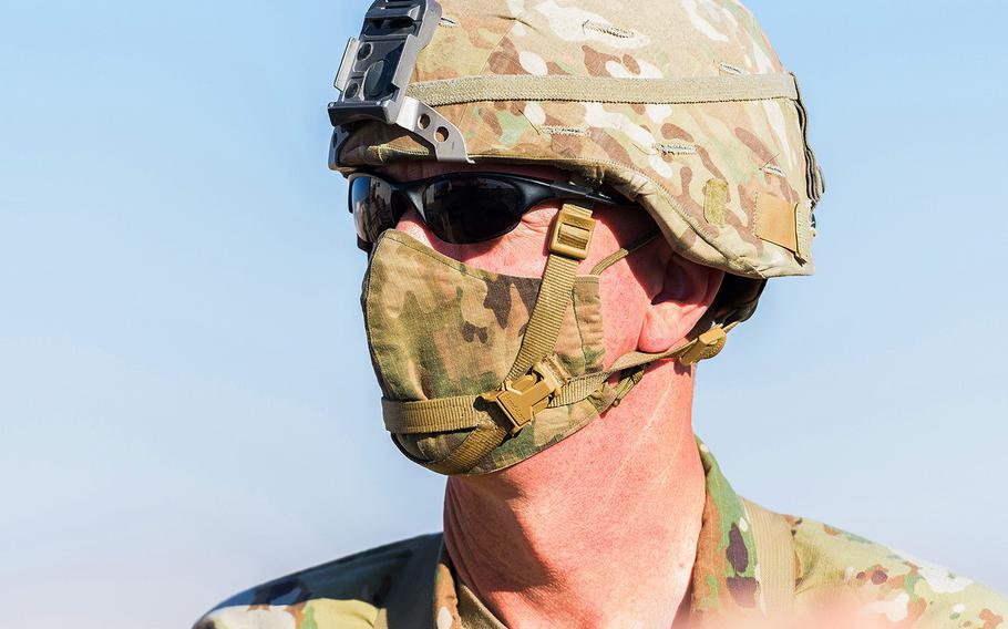 Brig. Gen. David Lesperance, the senior commander for the Army's National Training Center at Fort Irwin in California, wears a face mask as he inspects a 1st Infantry Division training rotation at the massive Mojave Desert training post on Sept. 20. 
