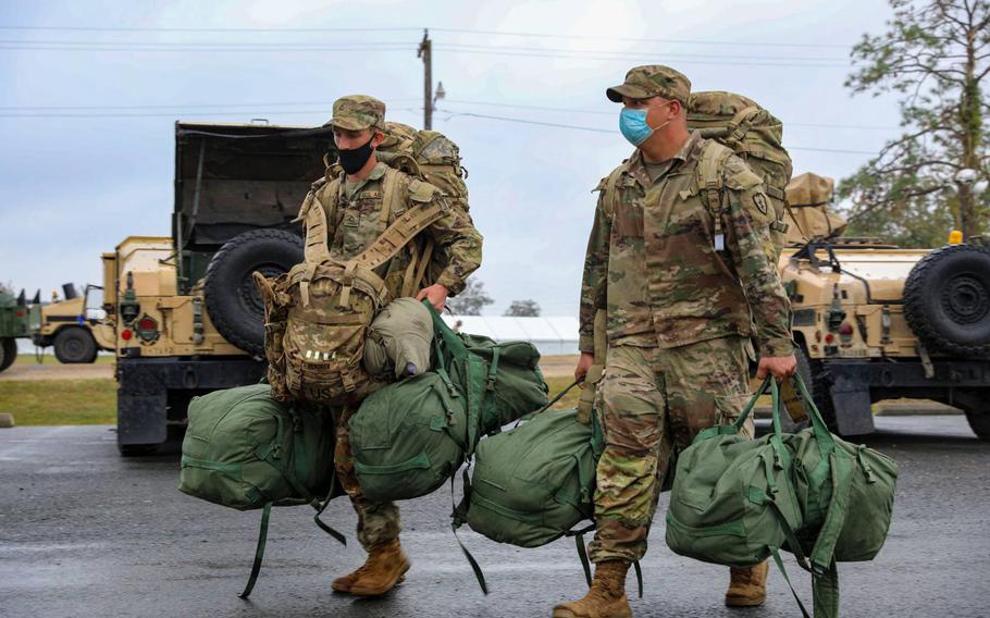 Soldiers with the 2nd Infantry Brigade Combat Team, 25th Infantry Division, move supplies from the tent city at the Joint Readiness Training Center at Fort Polk, La., Oct. 8, 2020, to more secure living quarters as Hurricane Delta approaches the state.