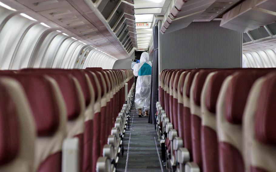 A sanitation crew works to disinfect the chartered Boeing 767 known as the Patriot Express at Osan Air Base, South Korea, July 14, 2020.